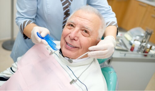 Older man smiling during treatment