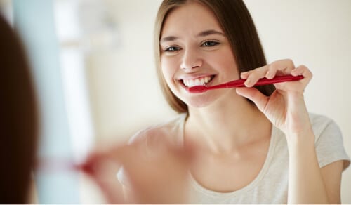 Young girl brushing teeth