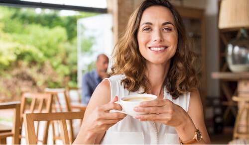 Woman smiling enjoying coffee